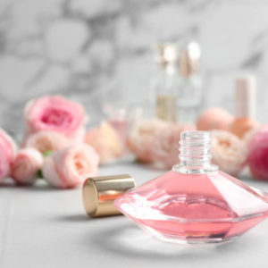 depositphotos_259631736-stock-photo-bottle-of-perfume-and-roses