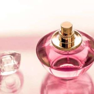 134408131-perfumery-spa-and-branding-concept-pink-perfume-bottle-on-glossy-background-sweet-floral-scent-glamo